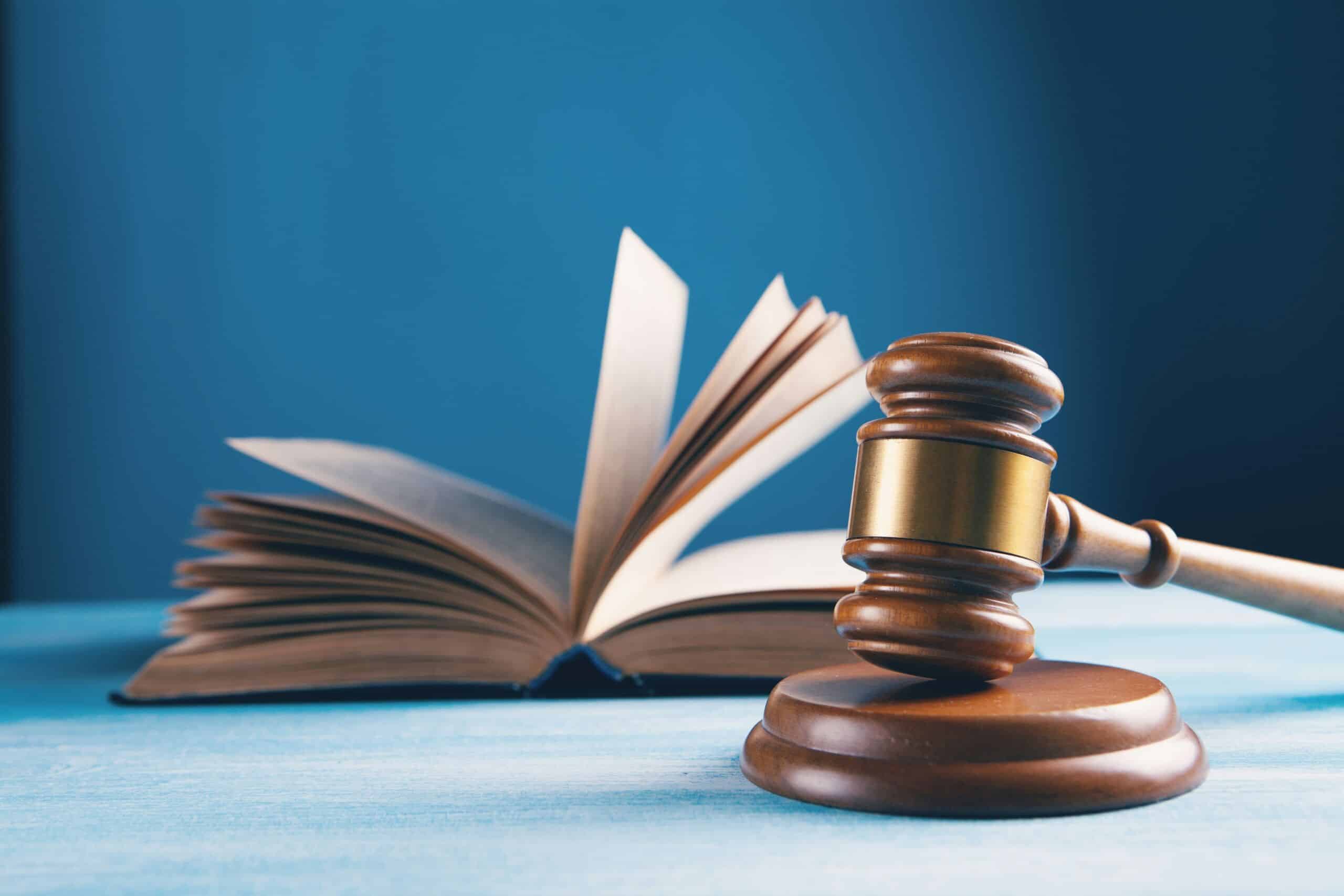 Judge's gavel and law book representing employment law and foreign national employment compliance in South Africa.